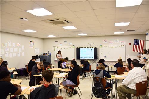 Teacher in front of classroom full of students